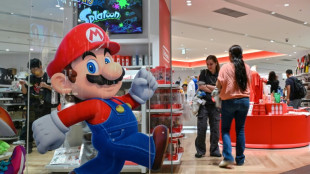 Asian stocks extend gains but US concerns hit dollar, boost gold