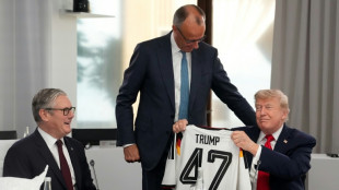 'On same team': Merz gifts Trump German football jersey