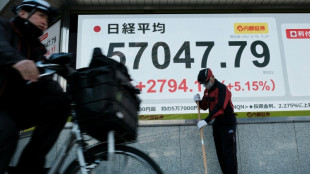 Tokyo stocks strike record high after Japanese premier wins vote